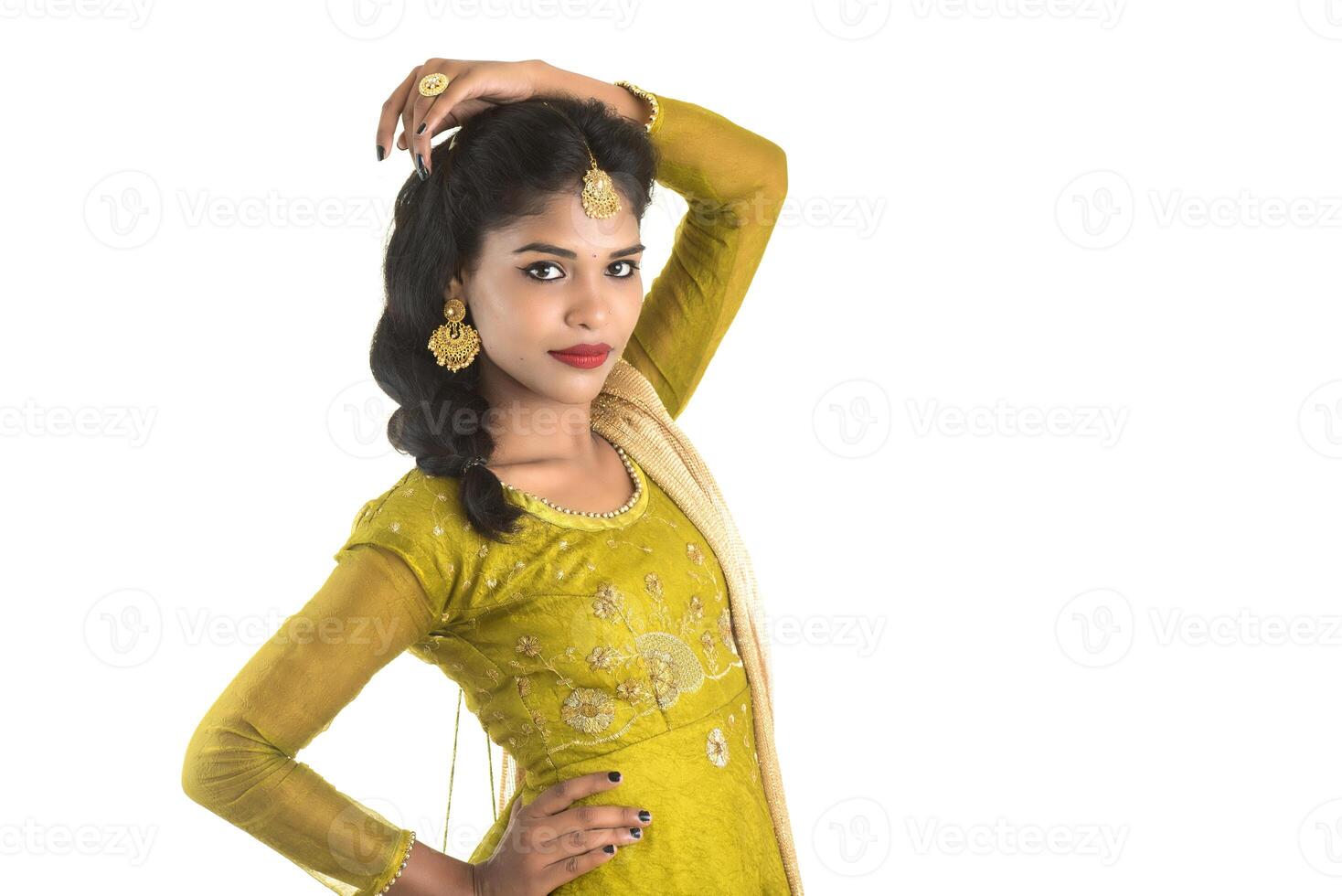 Portrait of beautiful traditional Indian girl posing on white background. photo