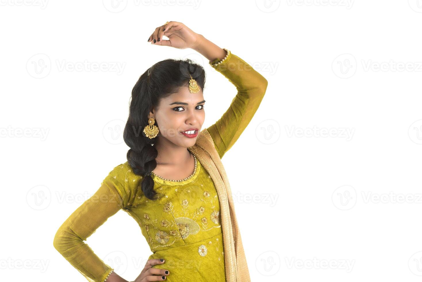 Portrait of beautiful traditional Indian girl posing on white background. photo