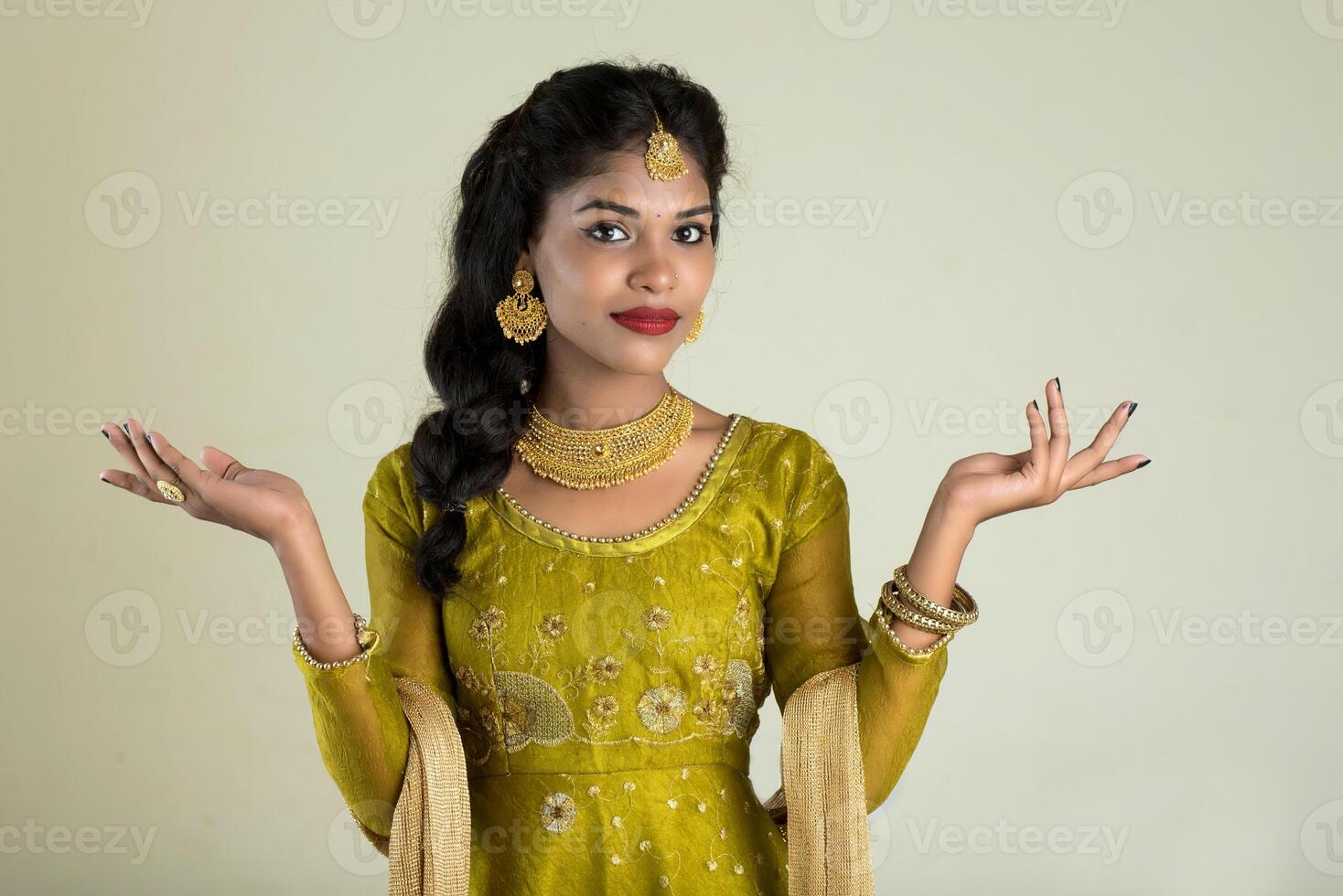 Portrait of beautiful traditional Indian girl posing on white background. photo