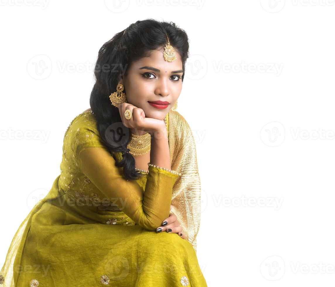 Portrait of beautiful traditional Indian girl posing on white background. photo