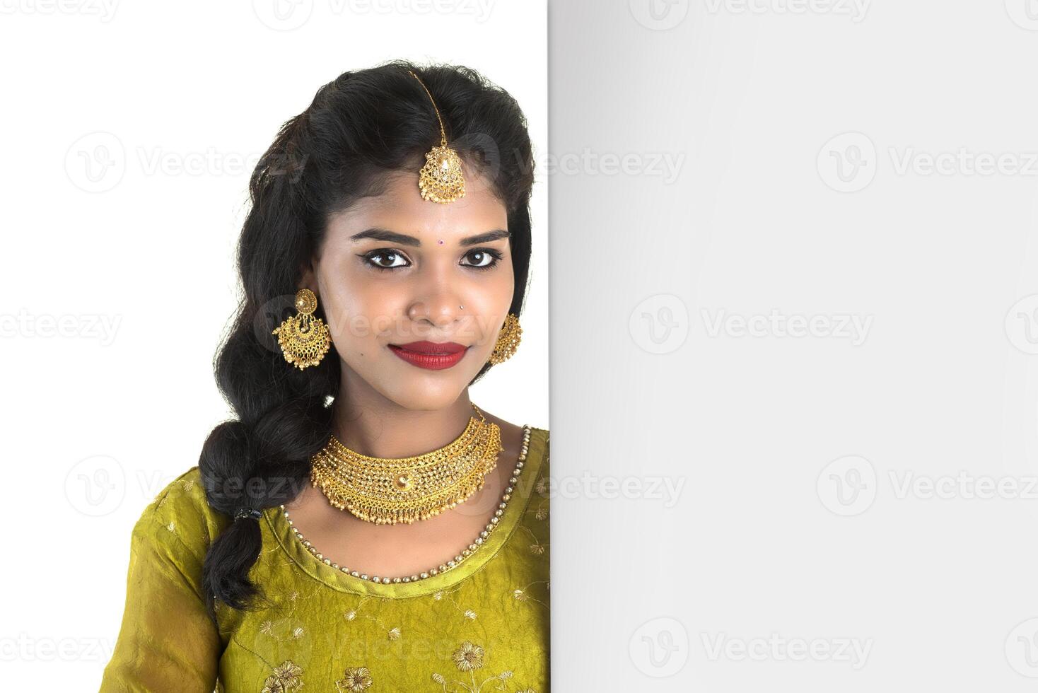 Traditional Girl holding and showing blank white sign board photo