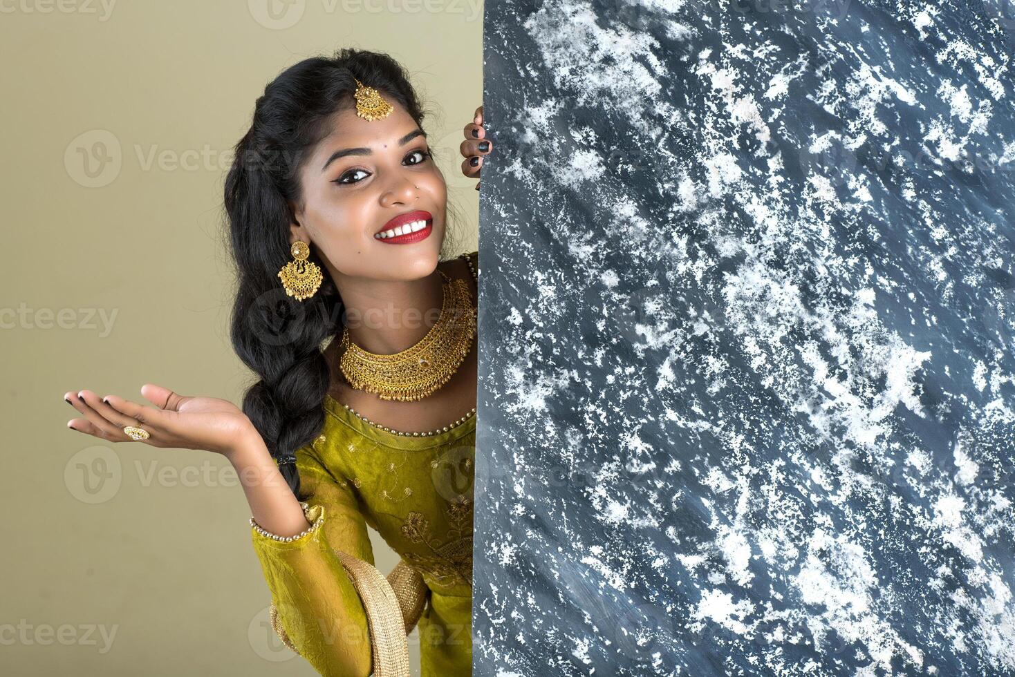 Traditional Girl holding and showing textured board photo