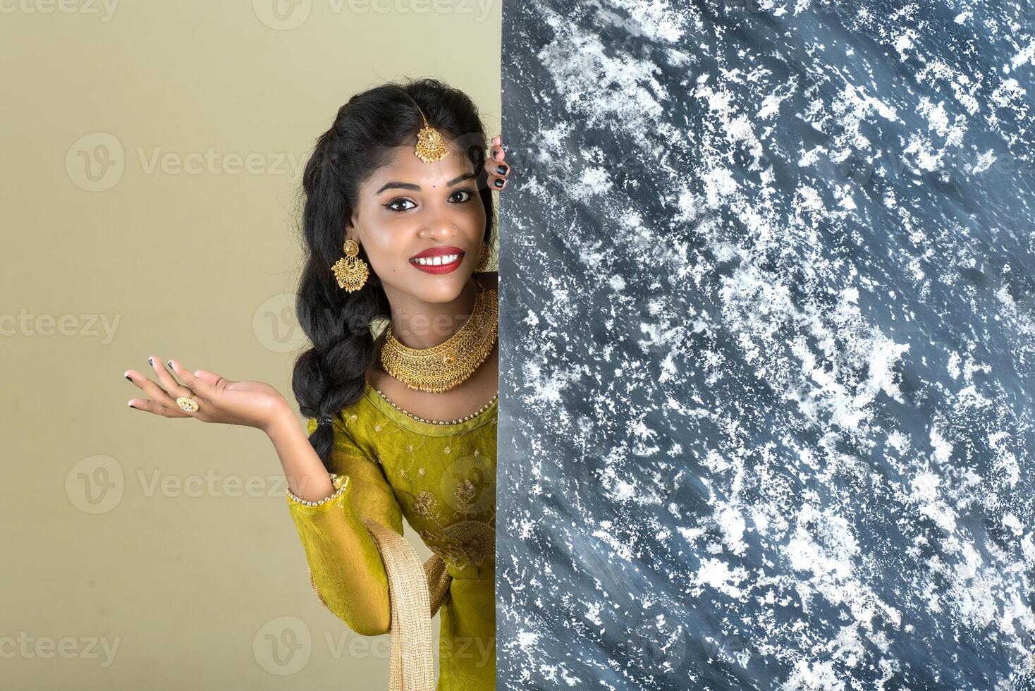 Traditional Girl holding and showing textured board photo
