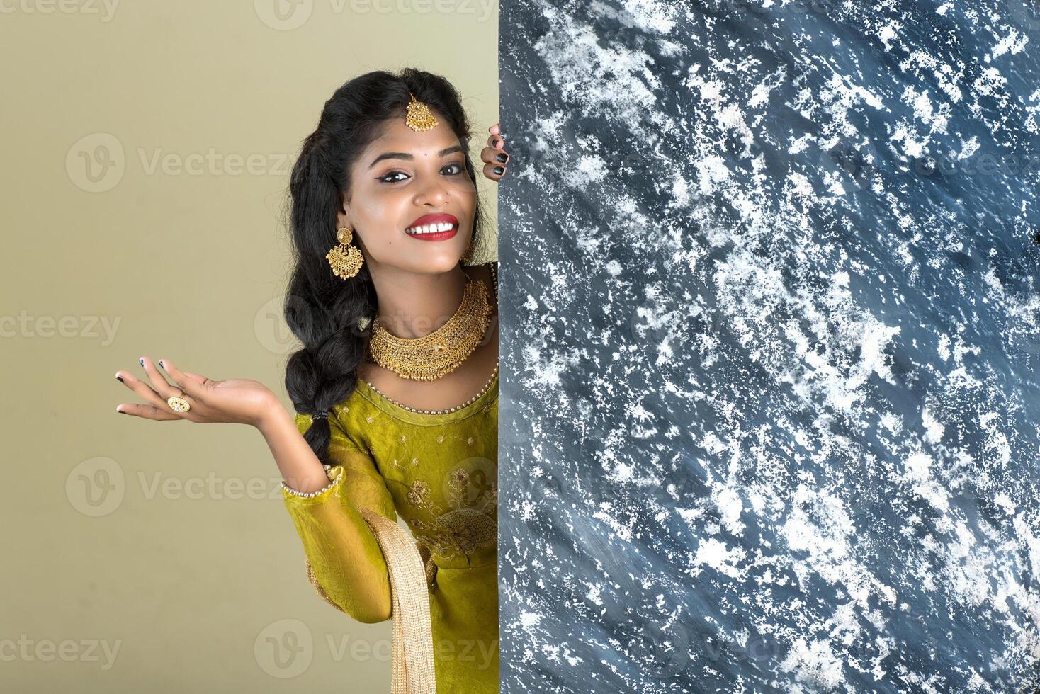 Traditional Girl holding and showing textured board photo