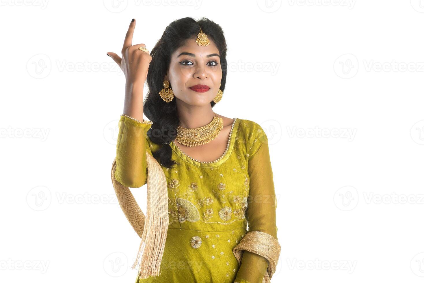 Smiling cheerful girl showing sign isolated on white background photo