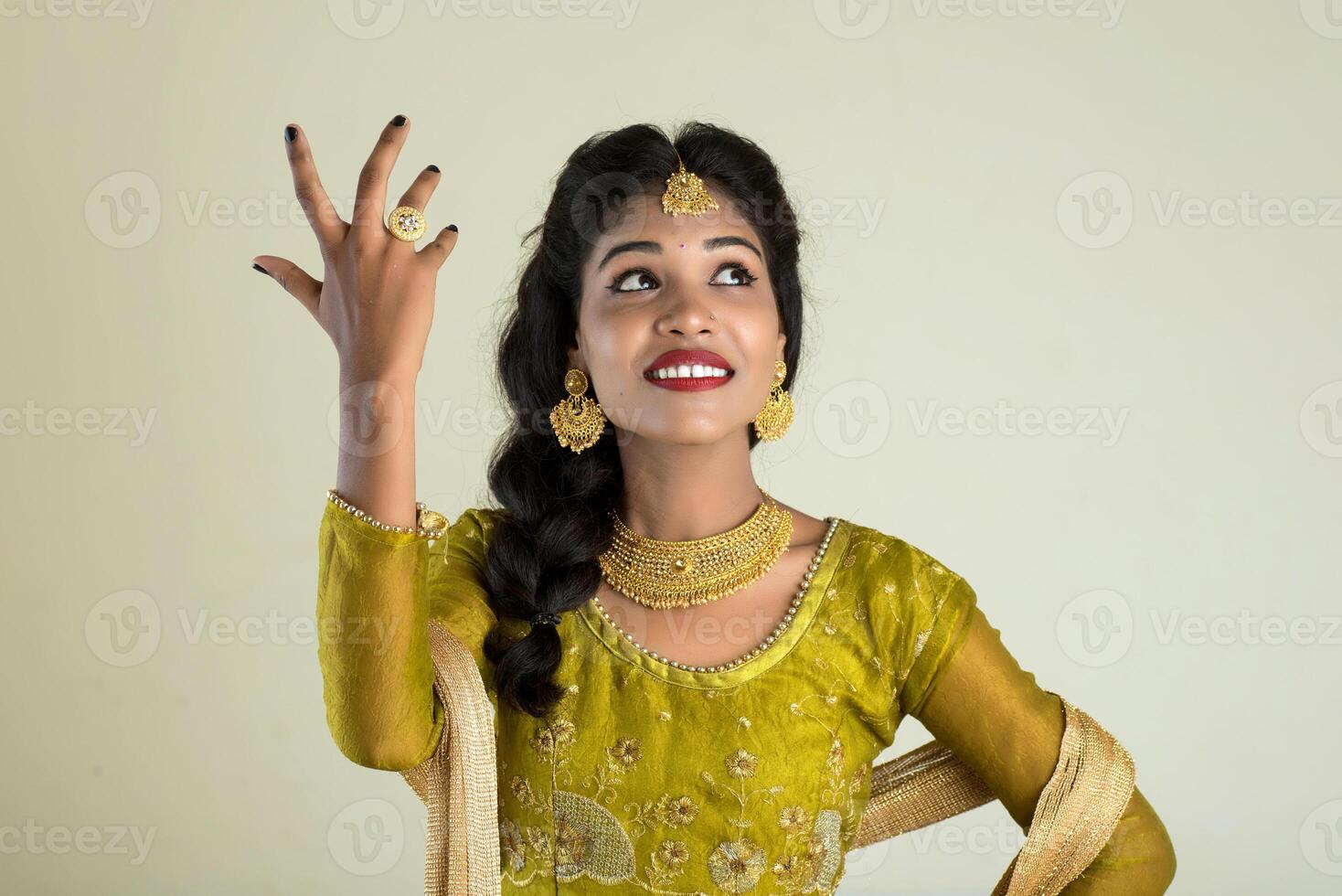 Smiling cheerful girl showing sign isolated on white background photo