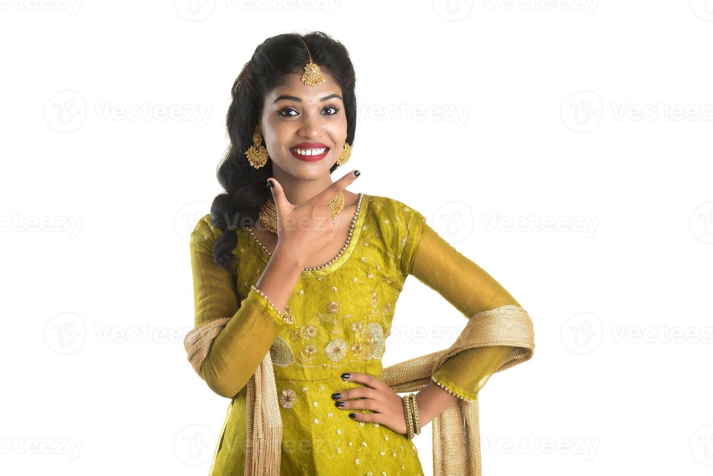 Smiling cheerful girl showing sign isolated on white background photo