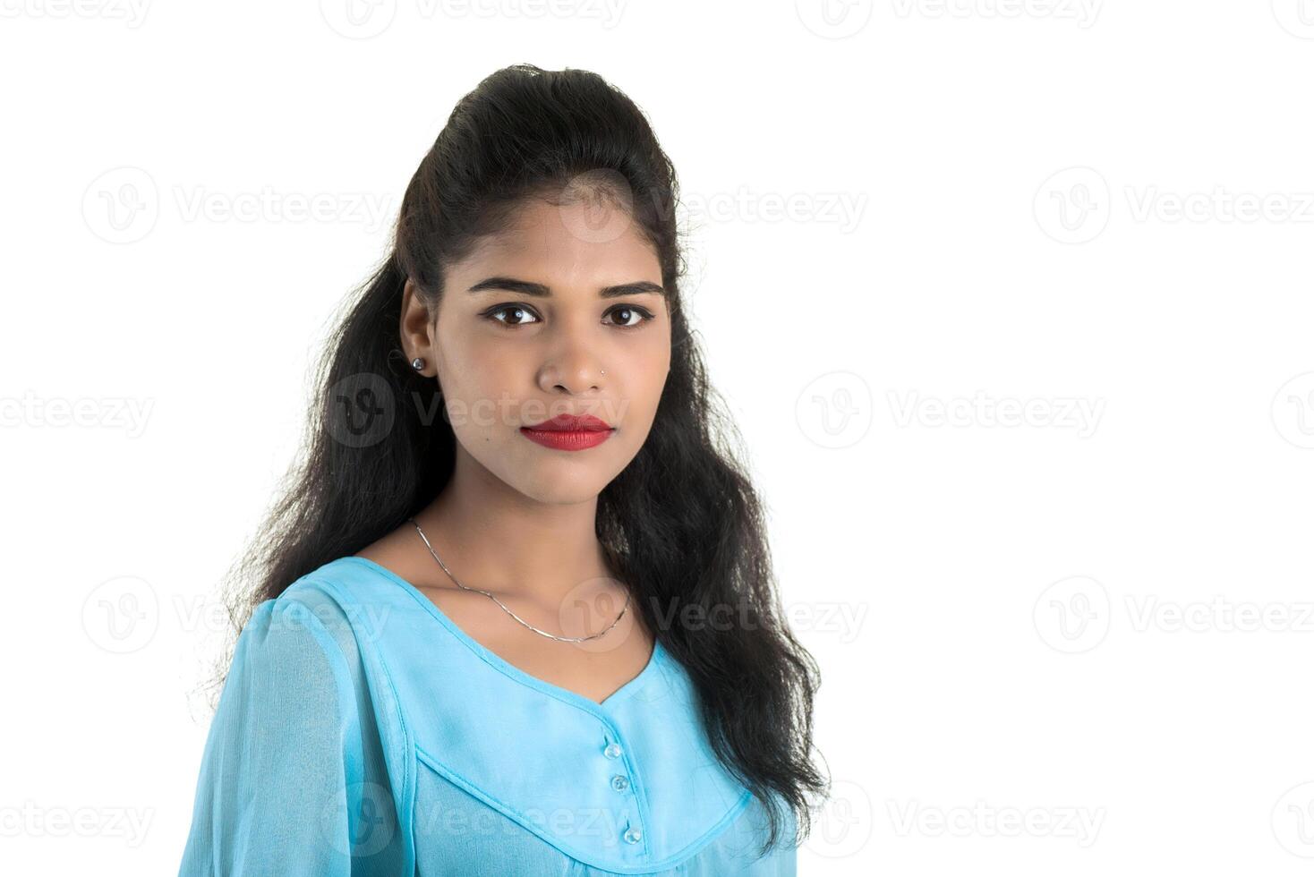 Portrait of beautiful young smiling girl posing on white background photo