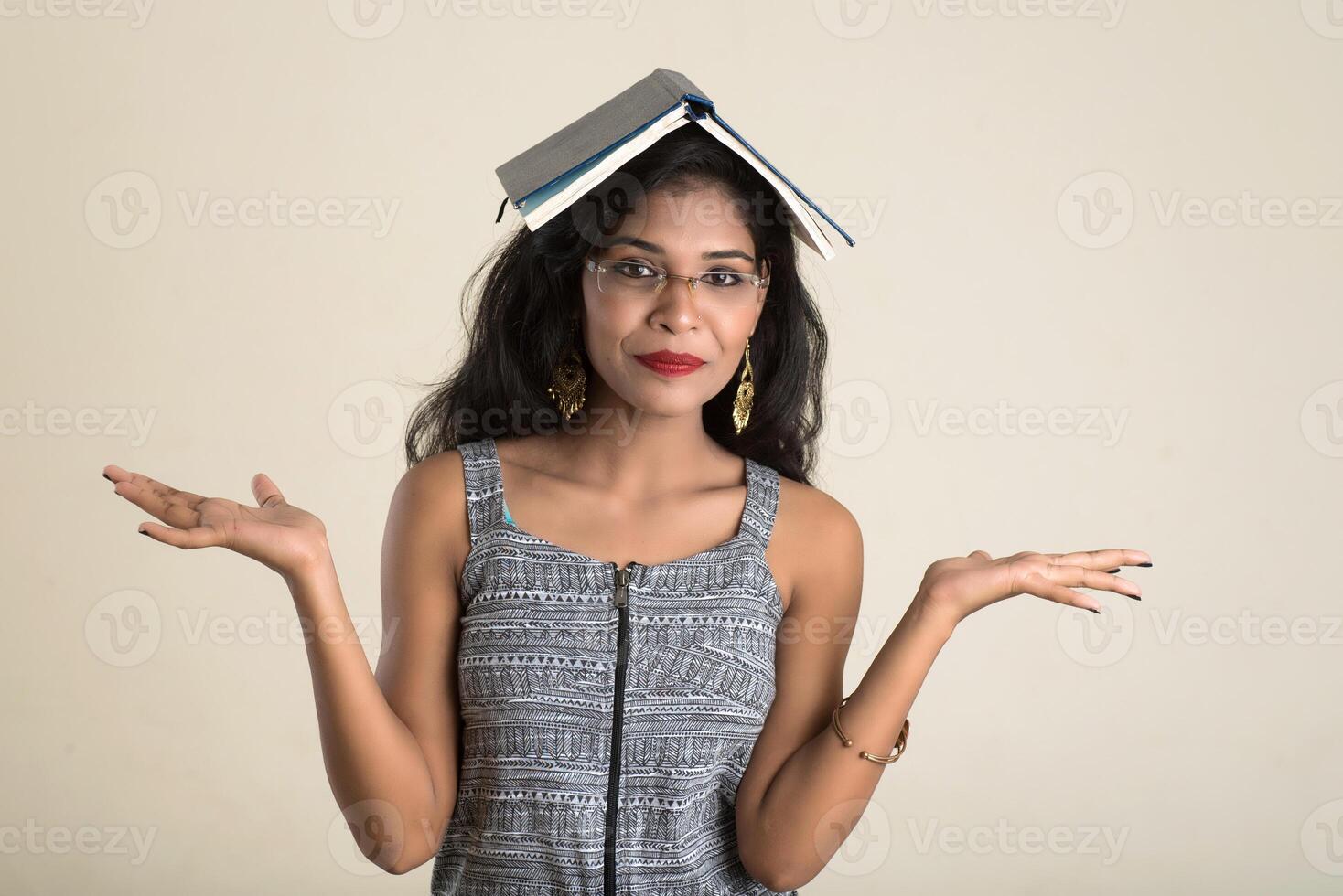 Pretty young girl holding and posing with book photo