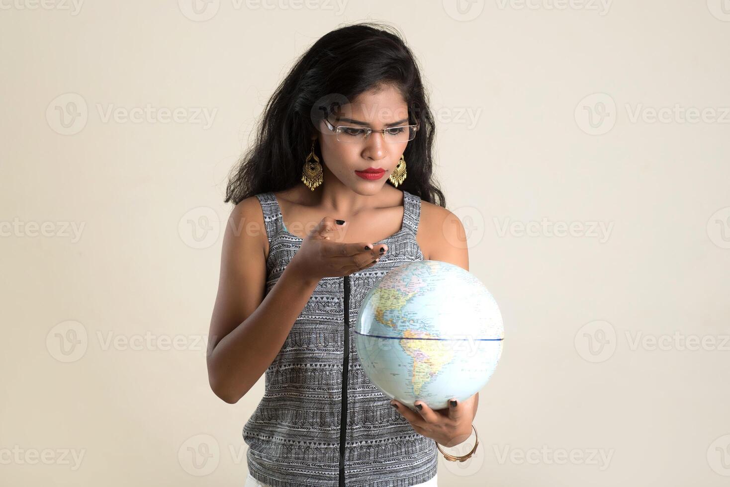 Portrait of young Girl holding and posing with a world globe. photo