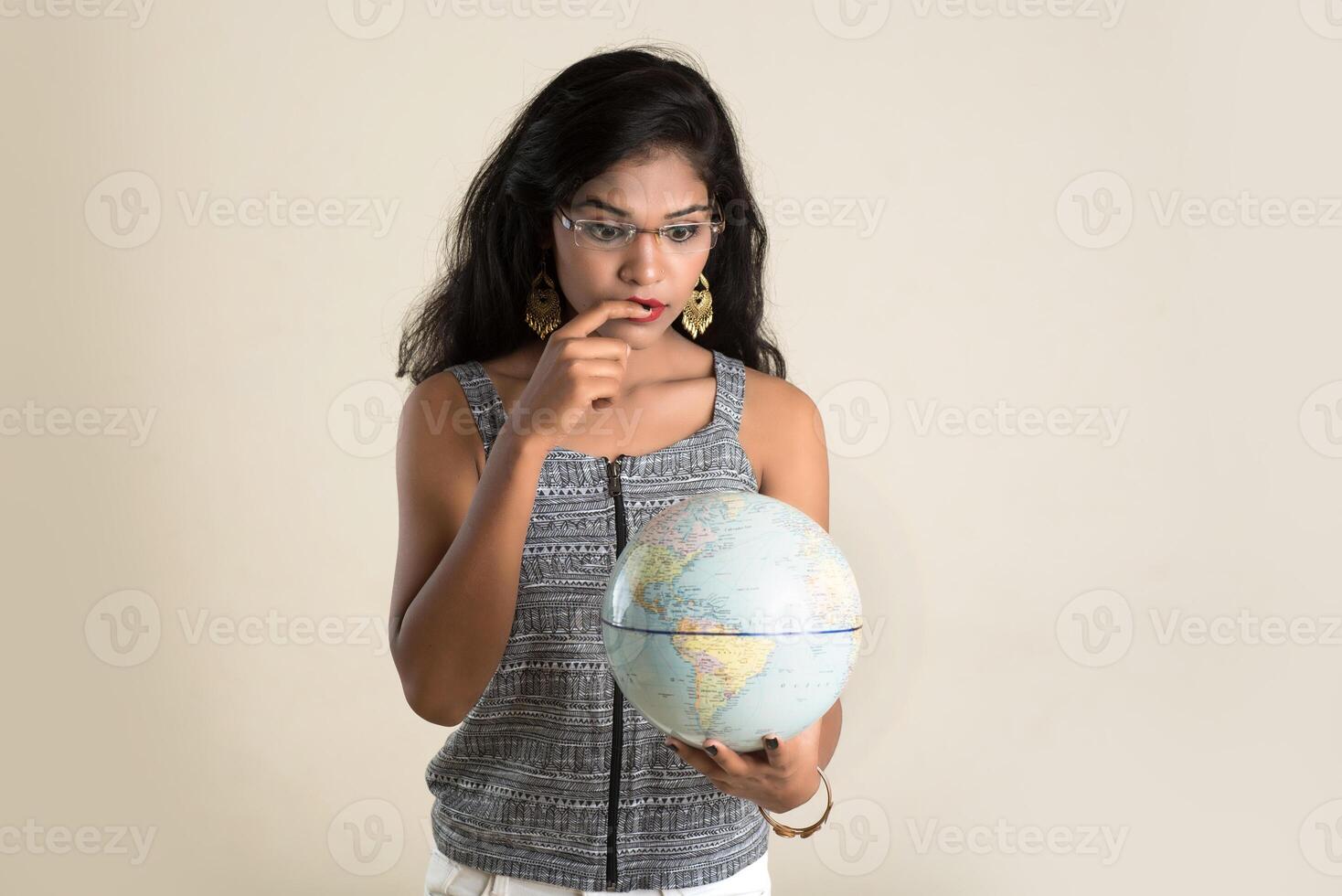 Portrait of young Girl holding and posing with a world globe. photo