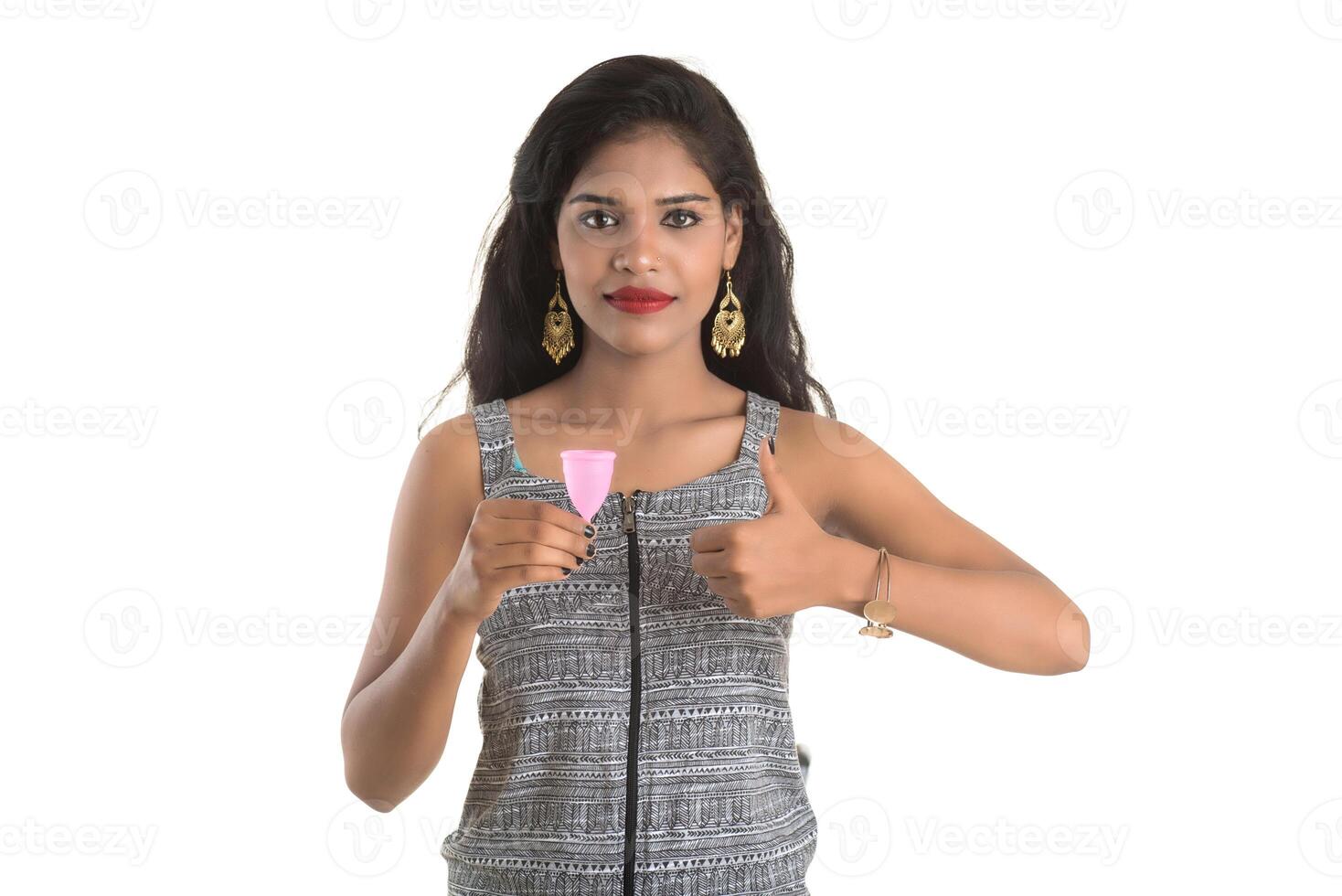 Close-up of young girl hands holding menstrual cup, Gynaecology concept, Showing thumbs up approving the use of the menstrual cup photo