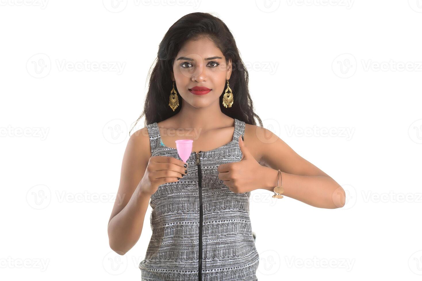Close-up of young girl hands holding menstrual cup, Gynaecology concept, Showing thumbs up approving the use of the menstrual cup photo