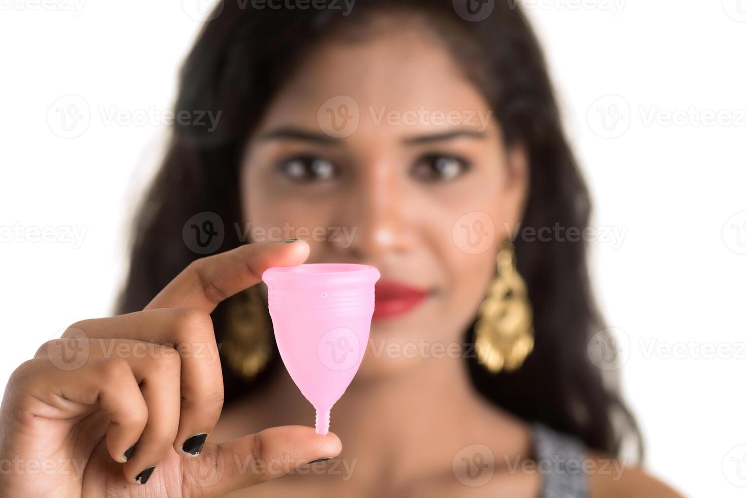 Close-up of young girl hands holding menstrual cup, Gynaecology concept, Showing thumbs up approving the use of the menstrual cup photo