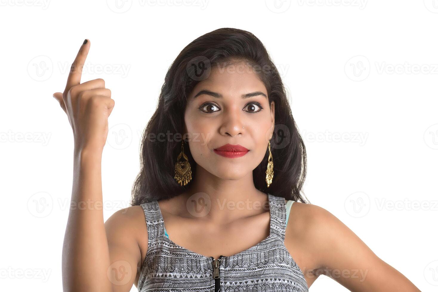 Smiling cheerful girl showing sign isolated on white background photo