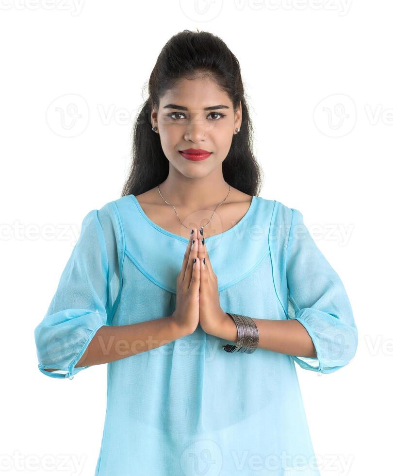 Beautiful Indian girl with welcome expression inviting, greeting Namaste photo