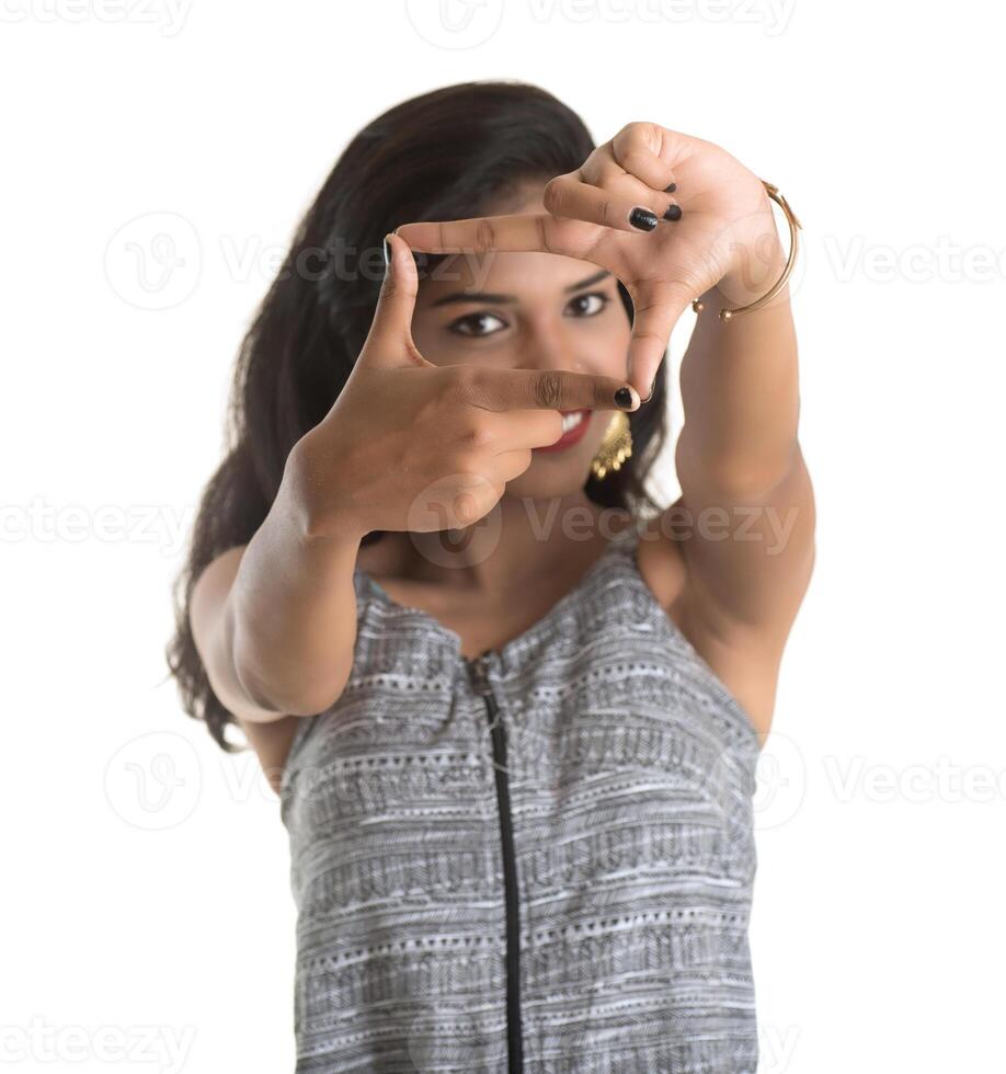Smiling cheerful girl showing sign isolated on white background photo
