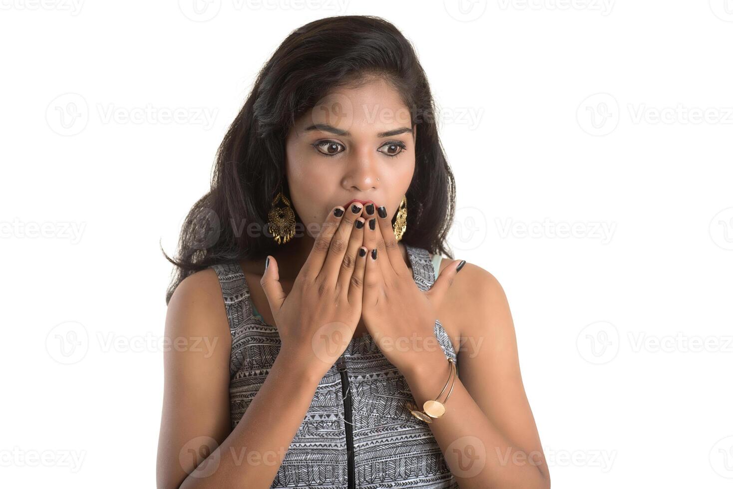 Smiling cheerful girl showing sign isolated on white background photo