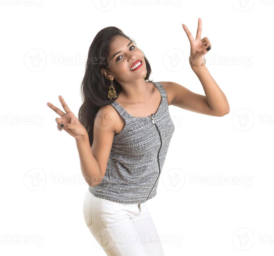 Smiling cheerful girl showing sign isolated on white background photo