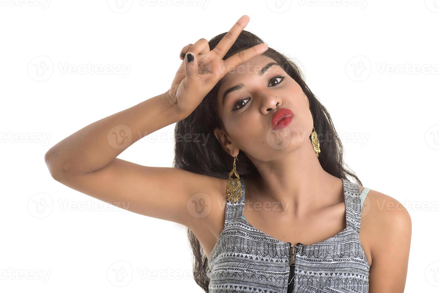 Smiling cheerful girl showing sign isolated on white background photo