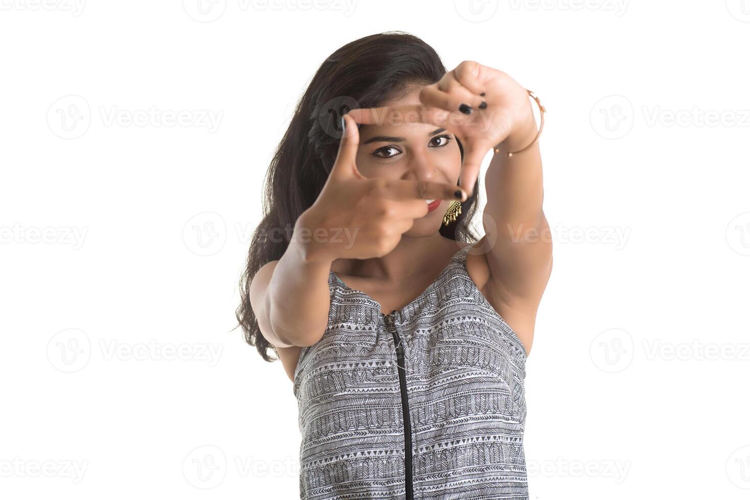 Smiling cheerful girl showing sign isolated on white background photo