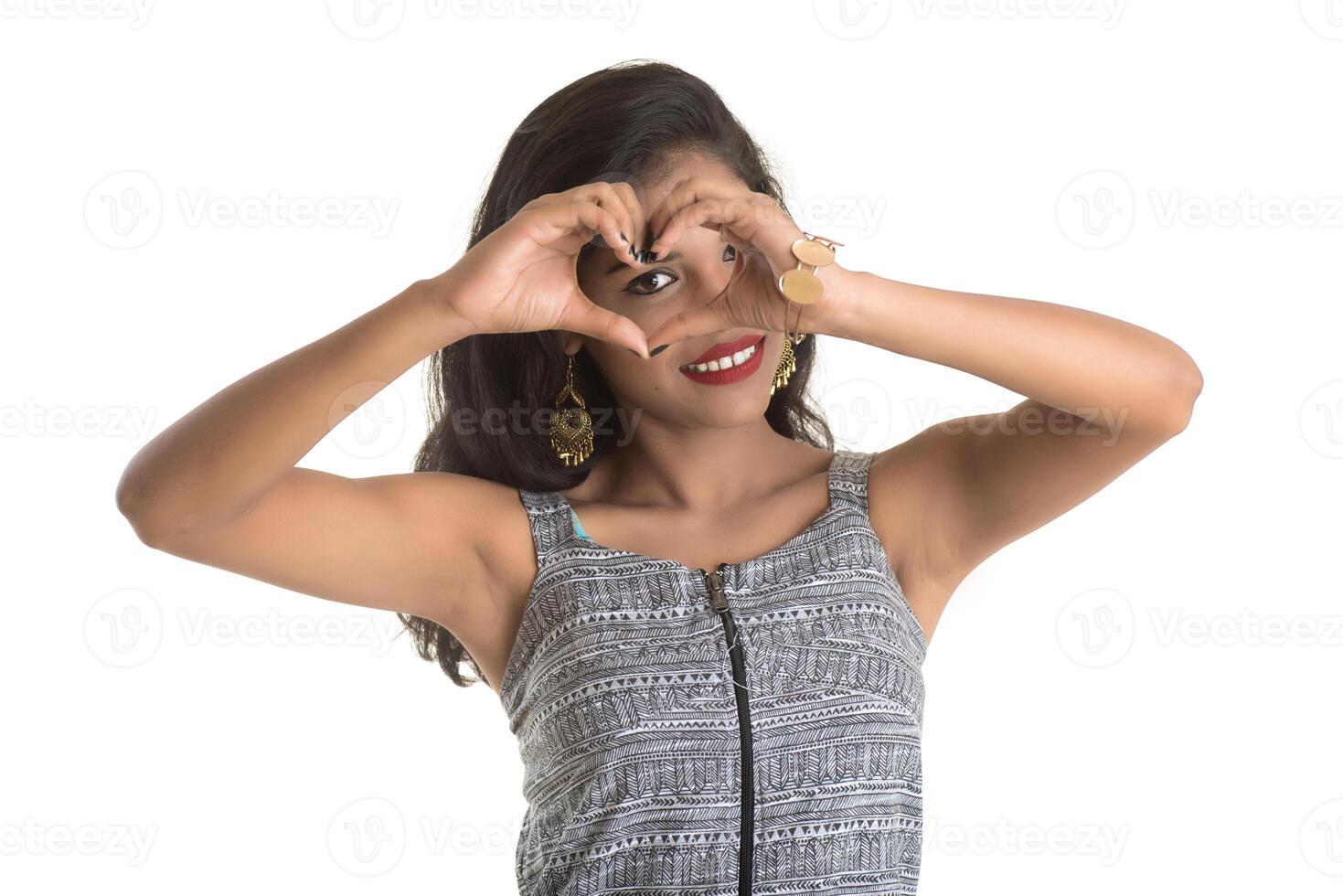 Smiling cheerful girl showing sign isolated on white background photo