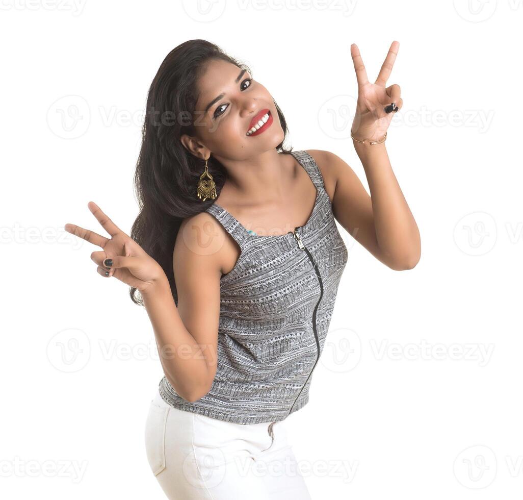 Smiling cheerful girl showing sign isolated on white background photo