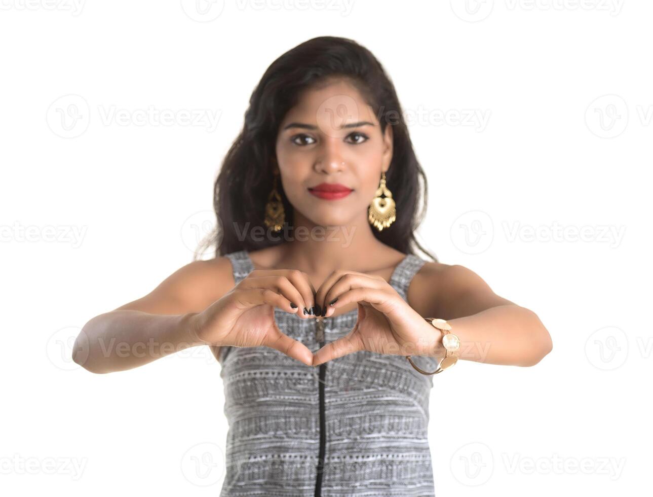 Smiling cheerful girl showing sign isolated on white background photo
