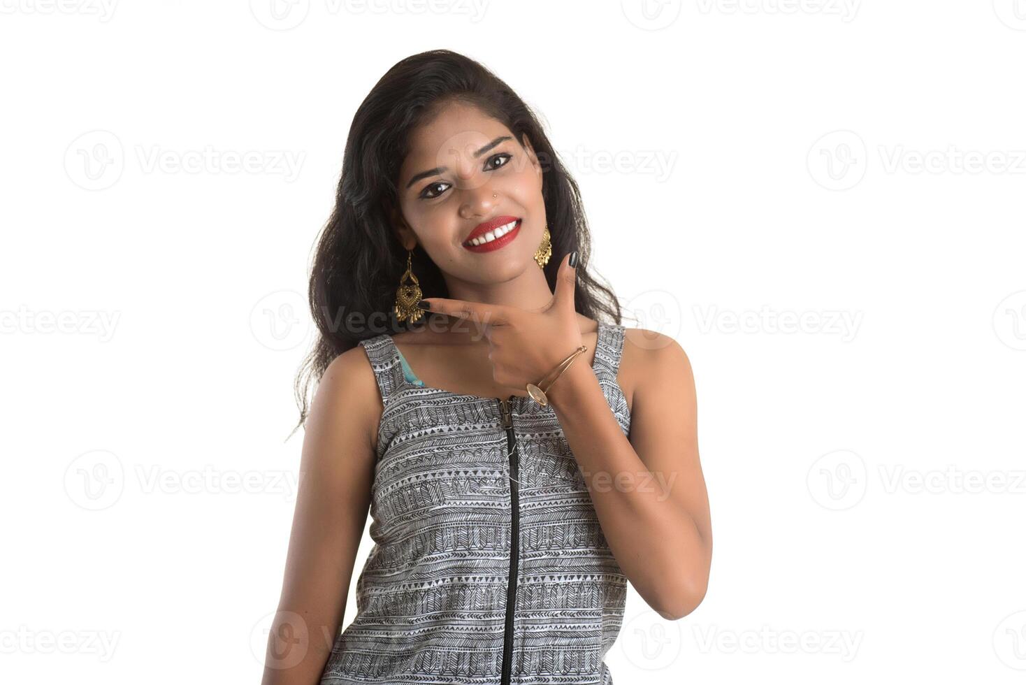Smiling cheerful girl showing sign isolated on white background photo
