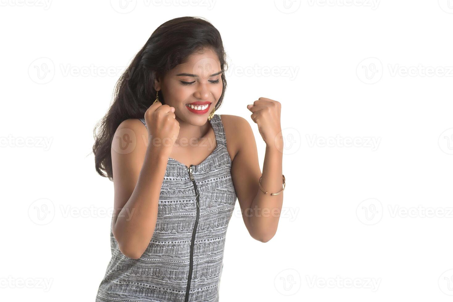 Smiling cheerful girl showing sign isolated on white background photo