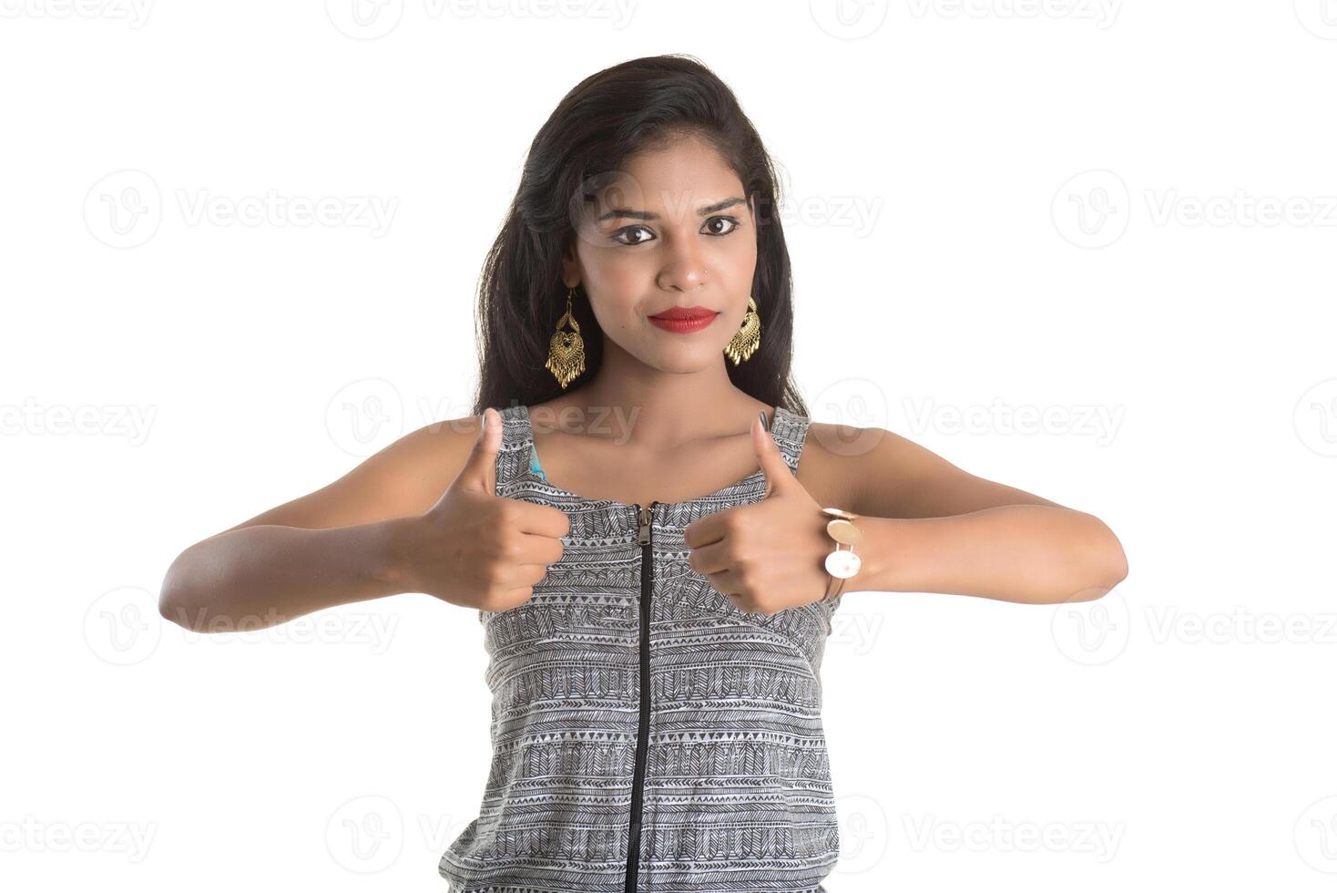 Smiling cheerful girl showing sign isolated on white background photo
