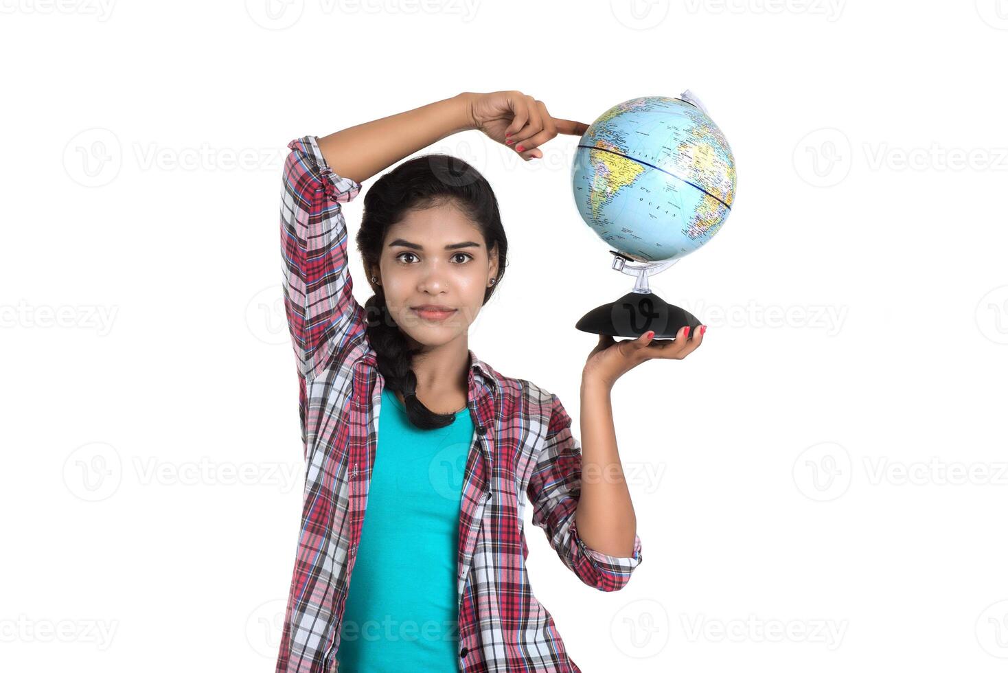 young woman holding the world globe and posing on a white background. photo