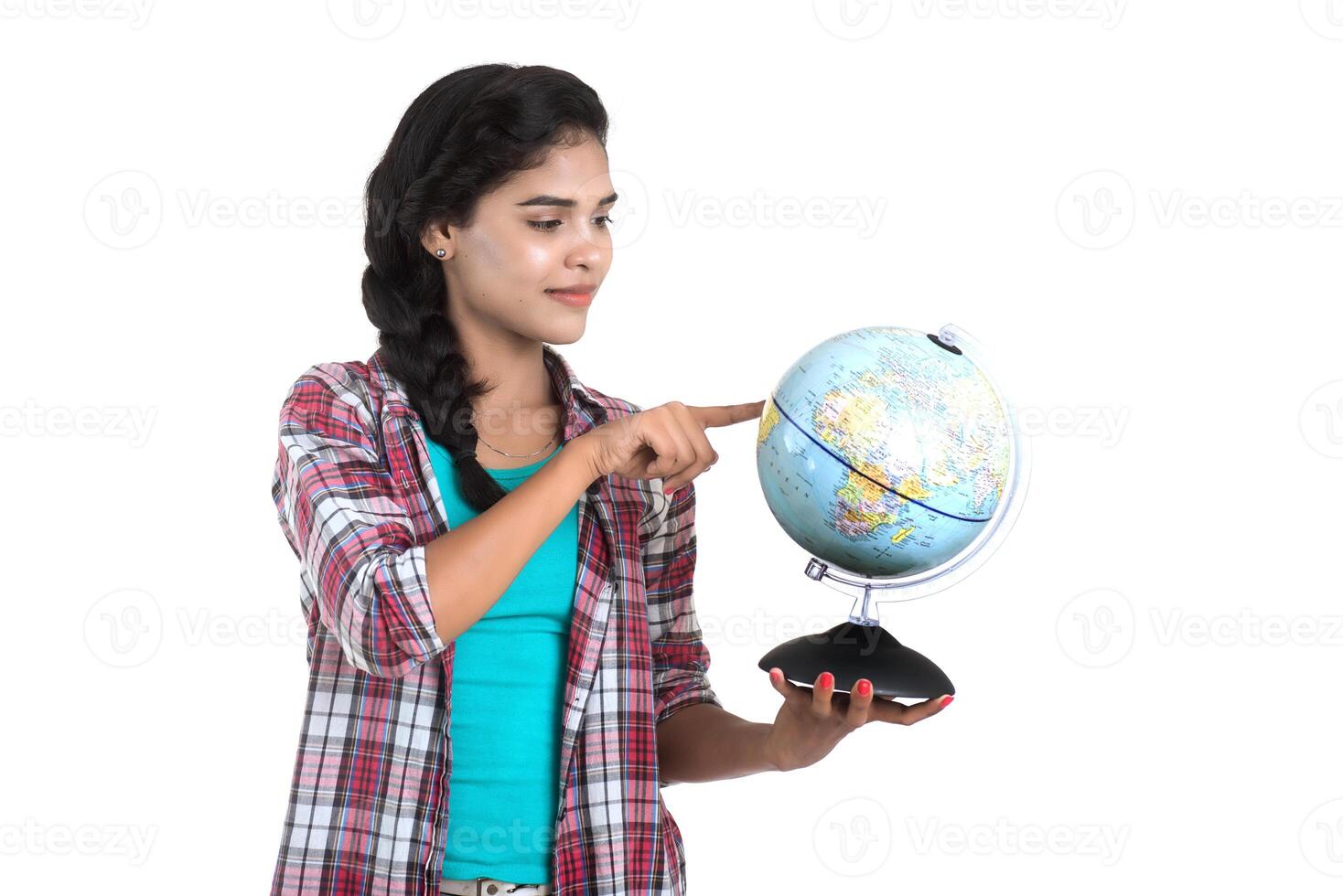 young woman holding the world globe and posing on a white background. photo