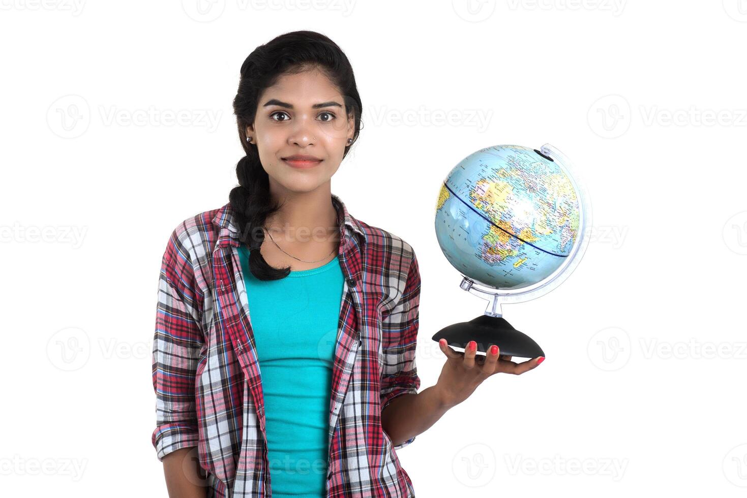 young woman holding the world globe and posing on a white background. photo