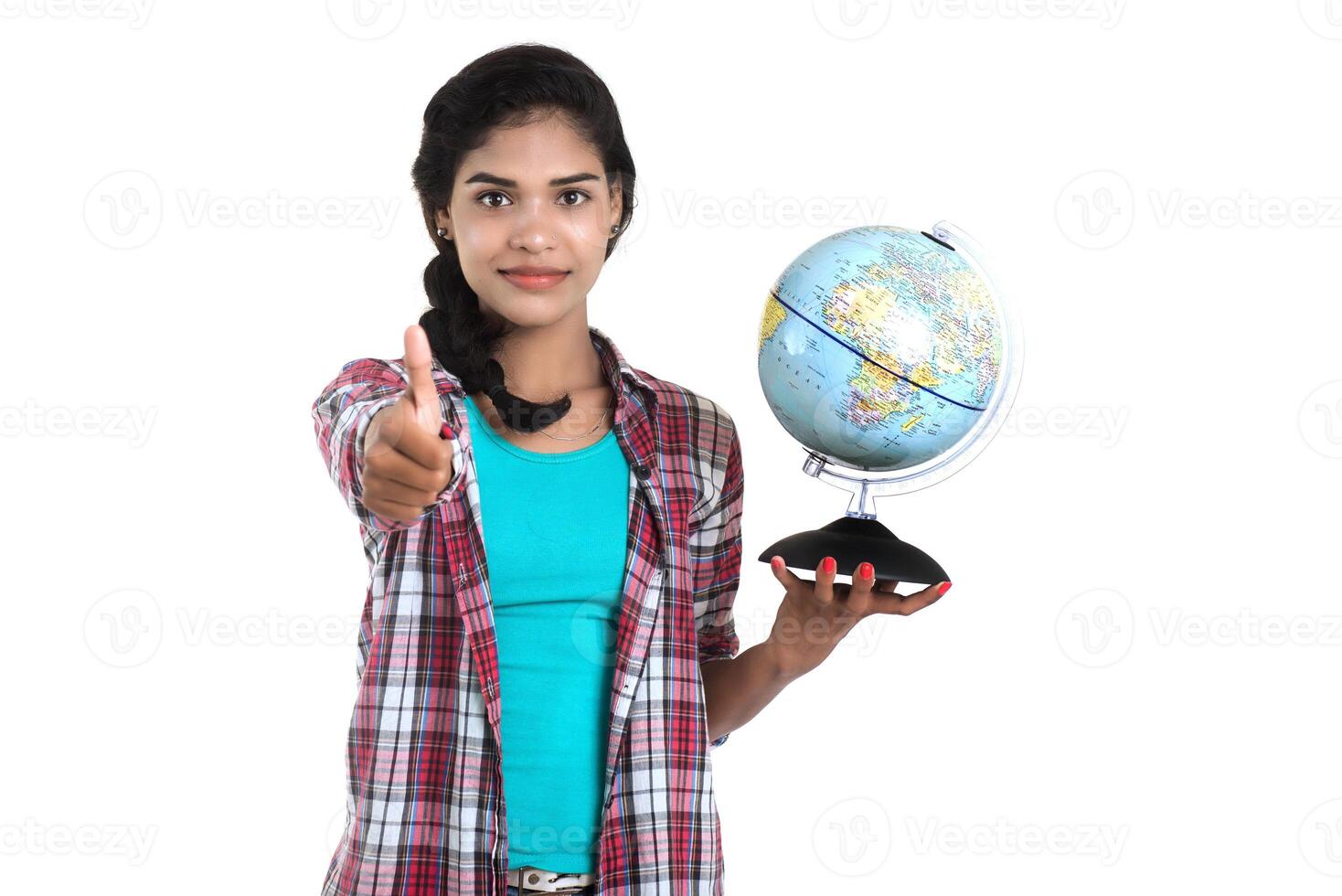 young woman holding the world globe and posing on a white background. photo