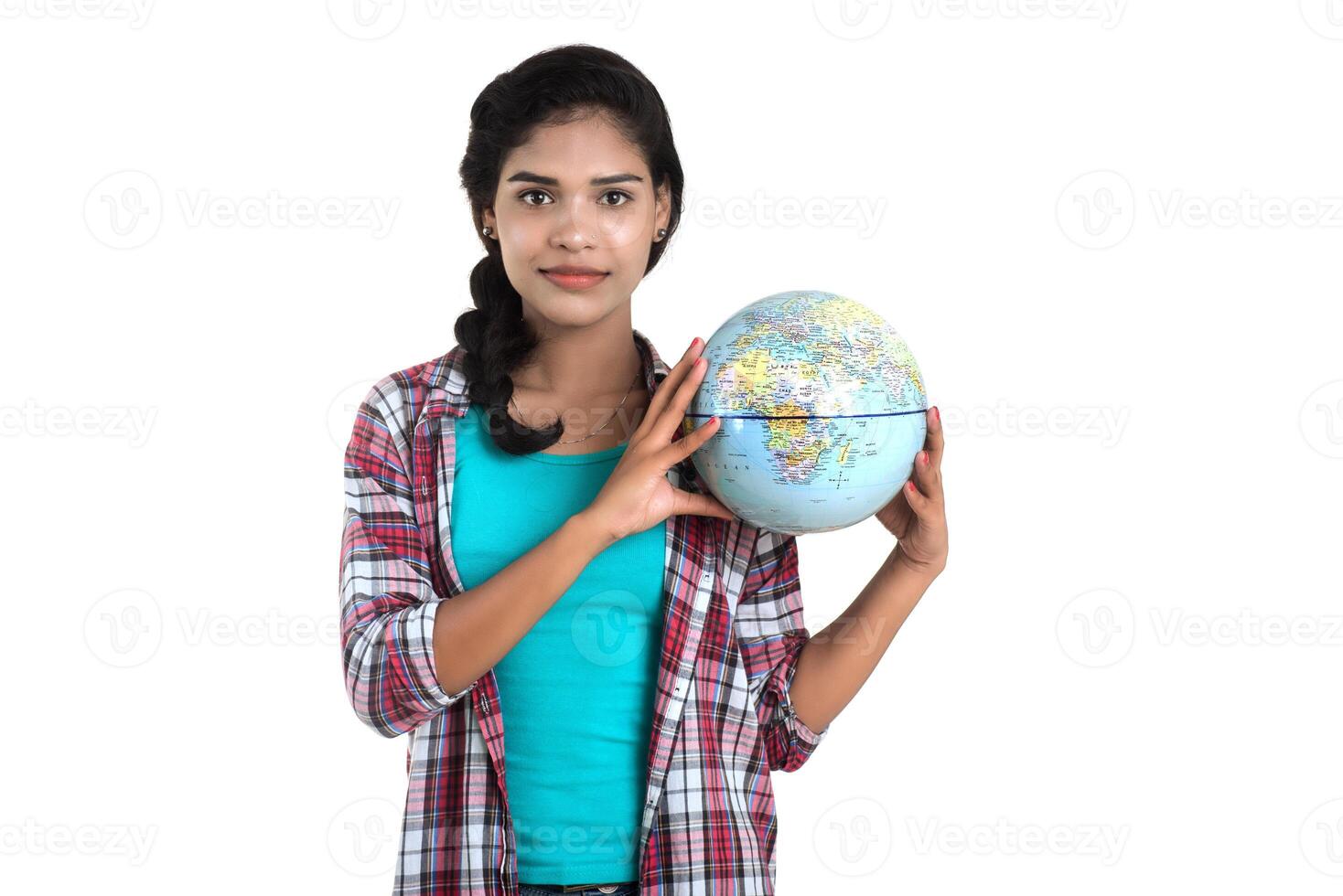 young woman holding the world globe and posing on a white background. photo
