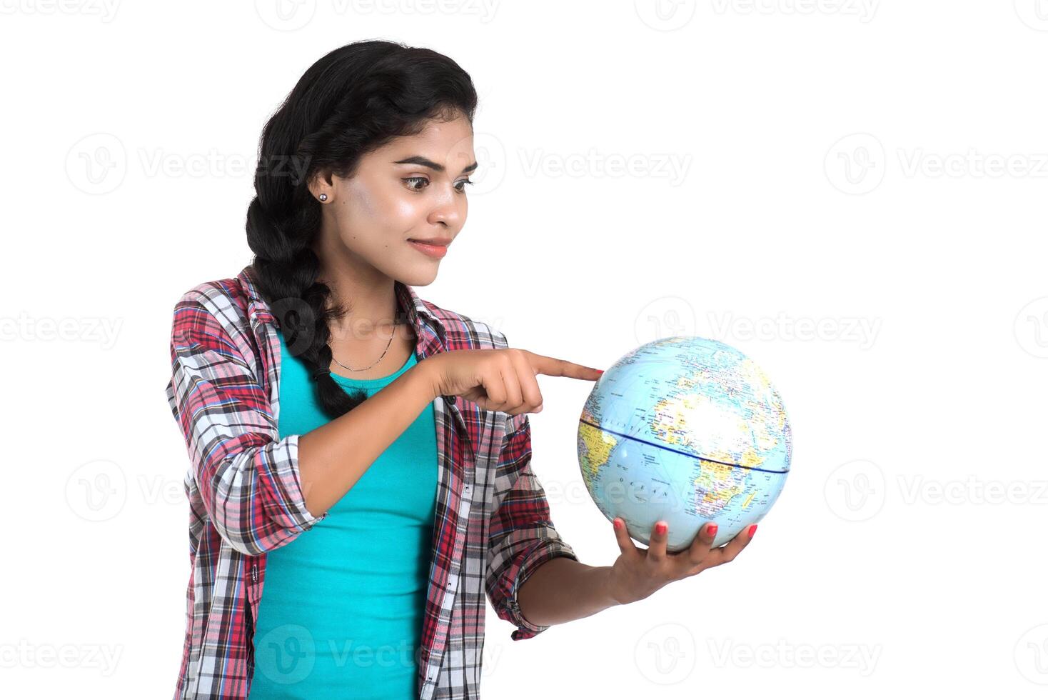 young woman holding the world globe and posing on a white background. photo