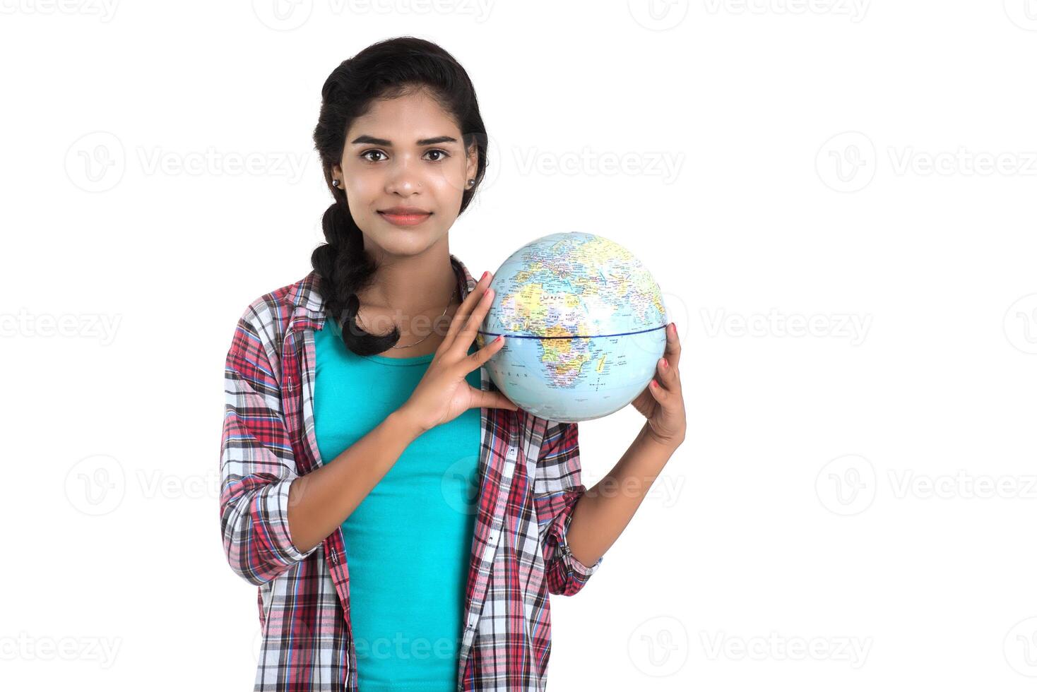 young woman holding the world globe and posing on a white background. photo