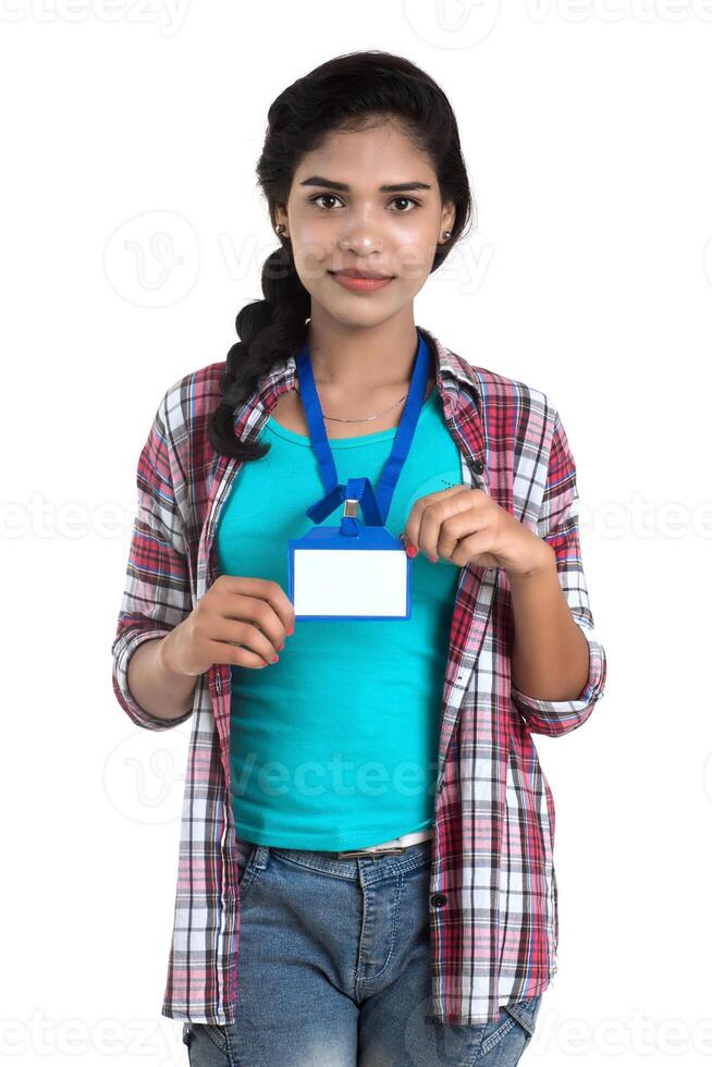 Young woman holding Identification white blank plastic id card. photo