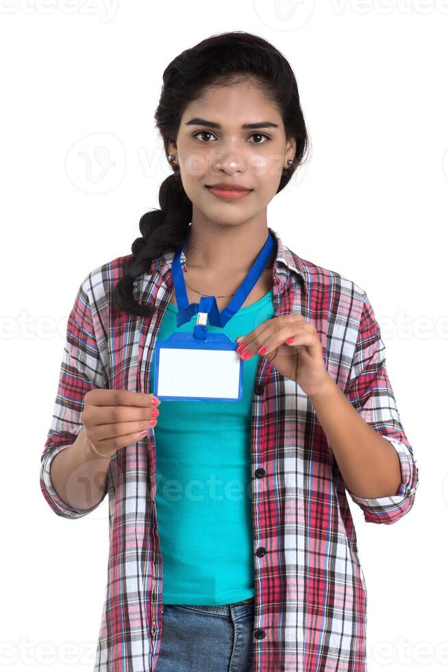 Young woman holding Identification white blank plastic id card. photo