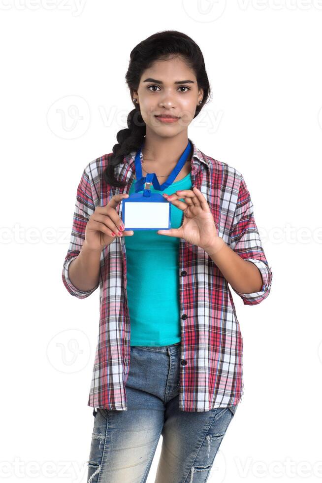 Young woman holding Identification white blank plastic id card. photo