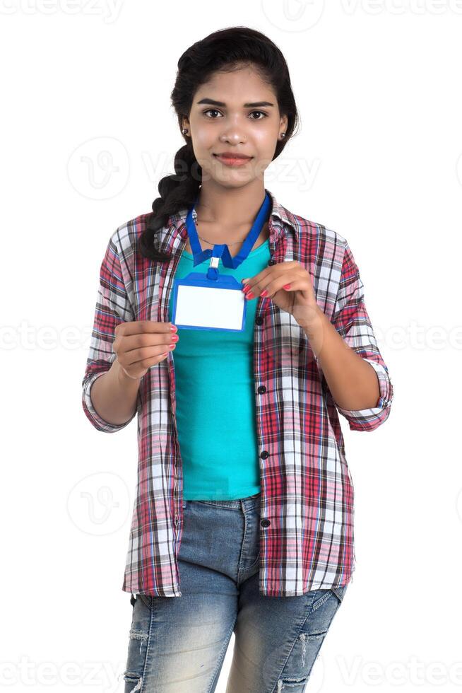 Young woman holding Identification white blank plastic id card. photo