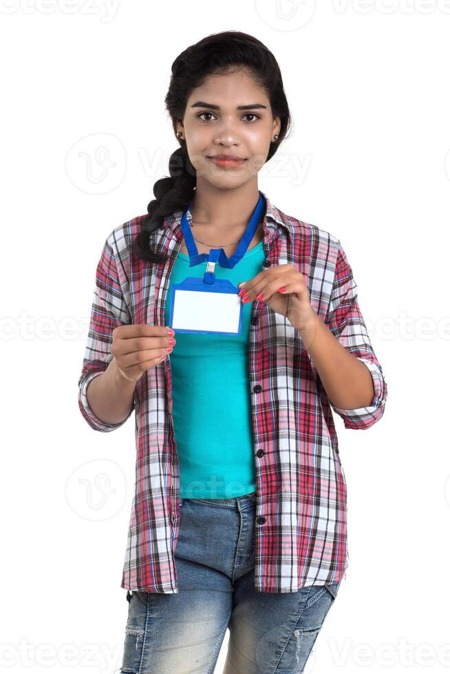 Young woman holding Identification white blank plastic id card. photo