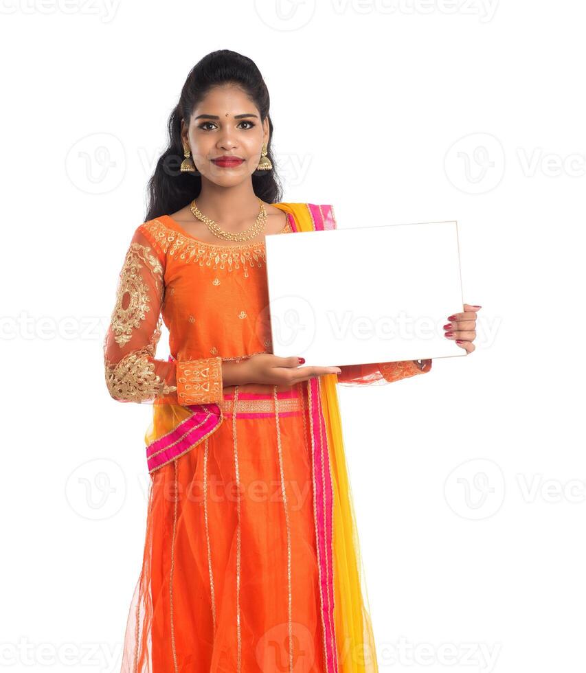 Traditional Girl holding and showing blank white sign board photo