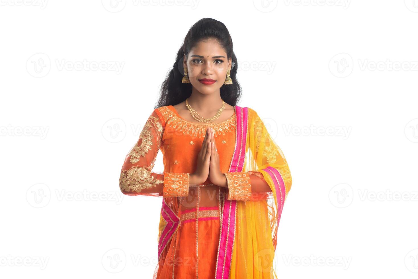 Beautiful Indian girl with welcome expression inviting, greeting Namaste photo