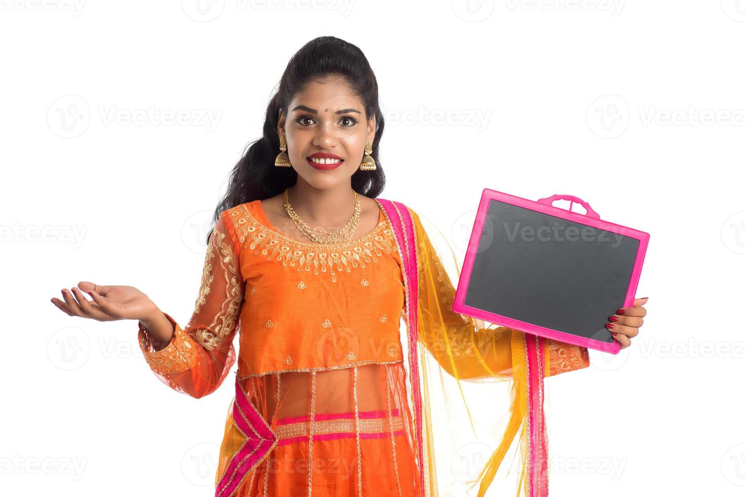 Beautiful young woman holding and posing with a blank chalkboard slate on a white background photo