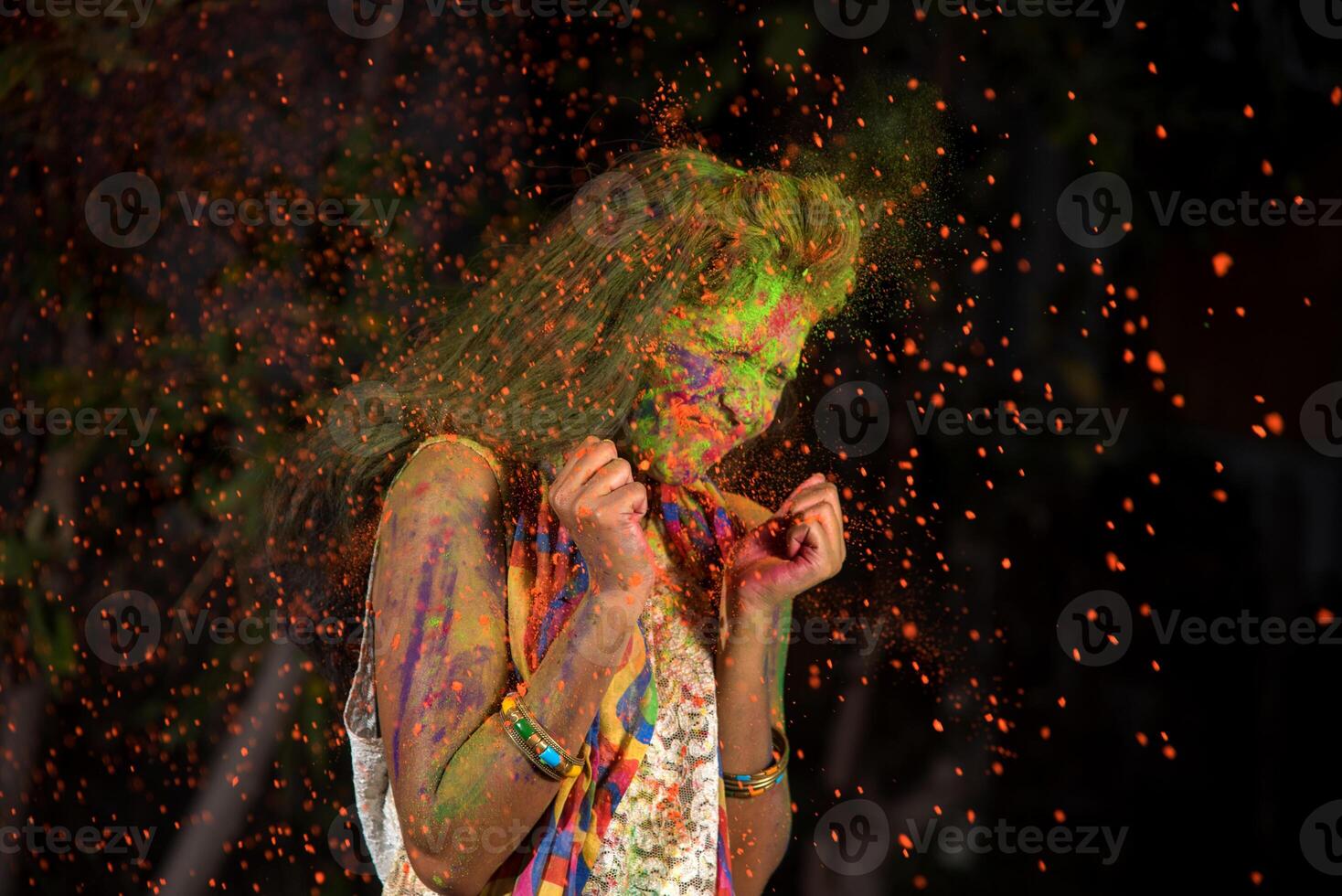 A young girl plays with colors. The concept for Indian festival Holi. color splash. photo