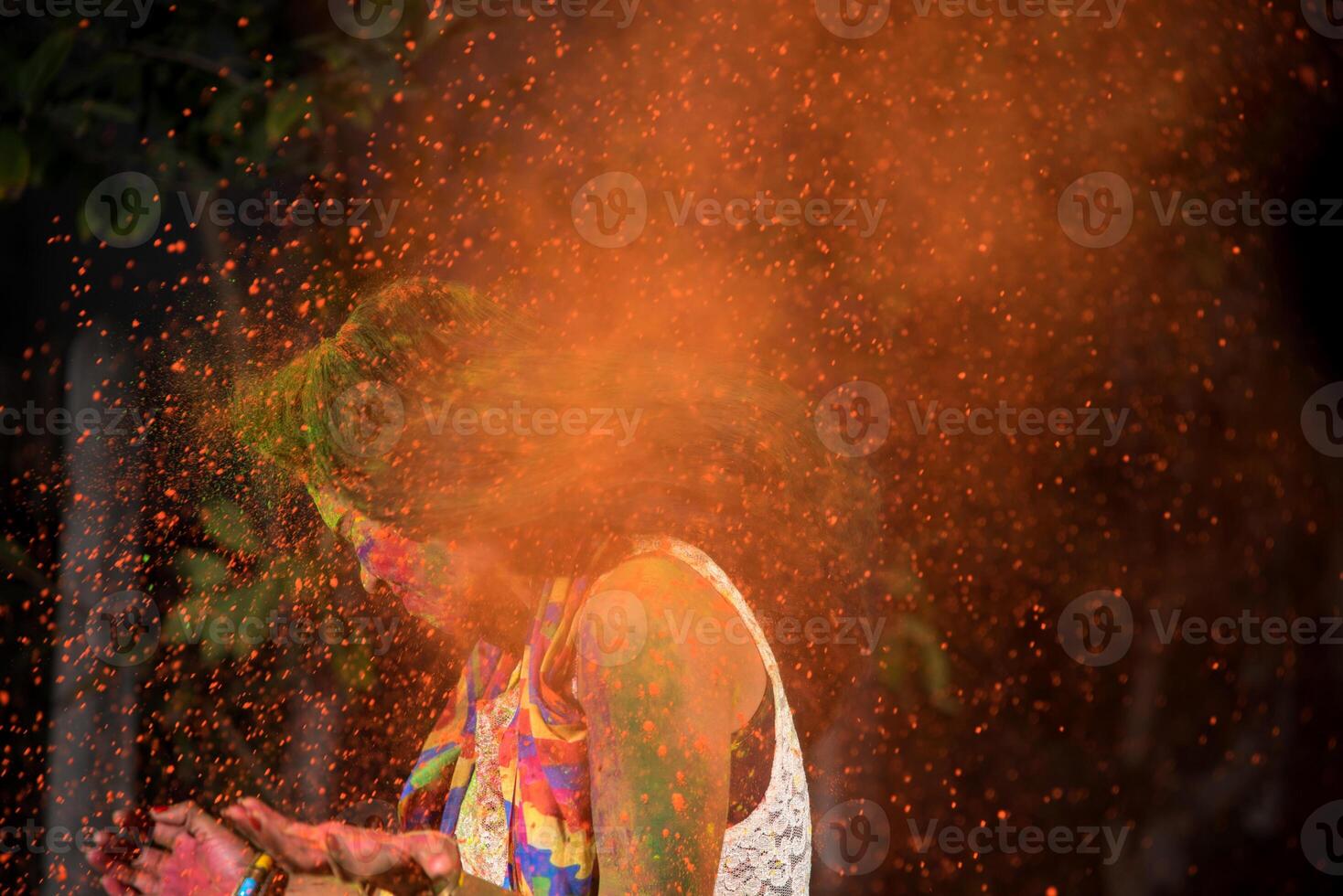 A young girl plays with colors. The concept for Indian festival Holi. color splash. photo