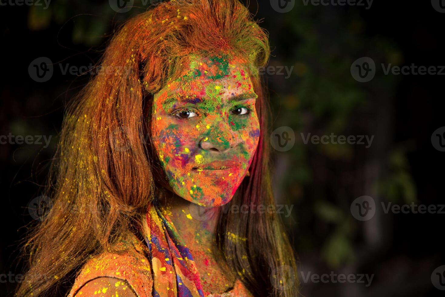 A young girl plays with colors. The concept for Indian festival Holi. color splash. photo