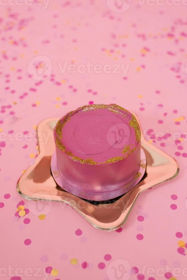 Trendy pink bento cake for Mom's day, birthday, Valentine's Day on a golden plate in the shape of a star on a pink background with confetti photo